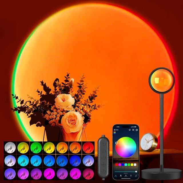 A sunset projection lamp casts a vivid orange and green circular glow on a wall, with a floral arrangement in front. A smartphone with a color wheel app, a remote control, and a clock are also visible. Sixteen small color options are shown at the bottom.