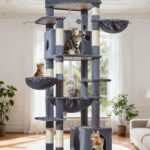 Five cats playing and lounging on a large multi-level cat tree in a bright, elegant living room.